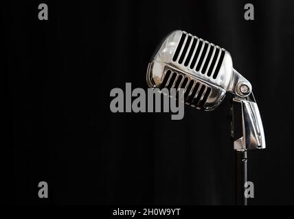 silver microphone in retro style on black background. Stock Photo