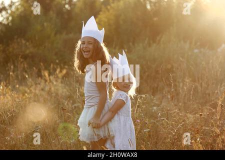 Two girls are playing princesses on the street. Stock Photo