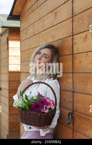 A languid girl with a basket in her hand. Stock Photo