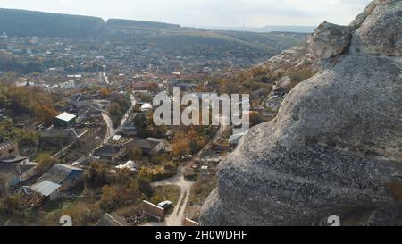 Town near the cliffs against blue sky. Aerial view Stock Photo