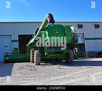 A John Deere Combine in for repair is parked at the door to the service bay of Prairieland Partners John Deere dealership during the first strike by John Deere workers in 35 years Stock Photo