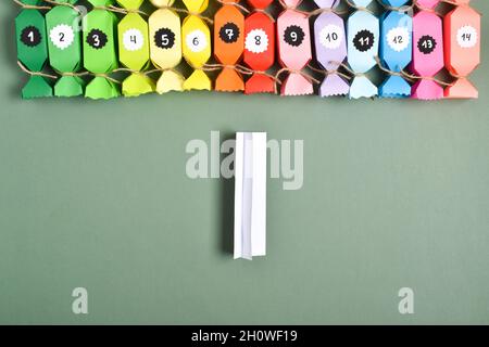 DO IT YOURSELF. Advent calendars made of colored paper in the shape of  sweets. Step-by-step instructions. Step 5. Bend a small strip for further  gluin Stock Photo - Alamy