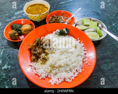 Meal in Bangladesh - Rice, Alo vorta, dhal, Shim borta and chicken curry Stock Photo