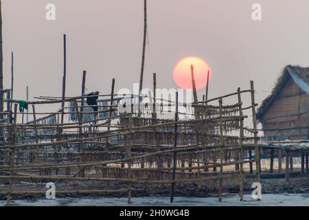 Sun rises over drying fish at Dublar Char Dubla island , Bangladesh. Stock Photo