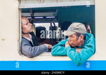 GOKTEIK, MYANMAR - NOVEMBER 30, 2016: Local men in a train near Gokteik Gok Teik viaduct, Myanmar Stock Photo