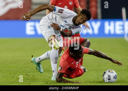 Toronto, Canada, October 13, 2021: Michael Amir Murillo (white) of Team Panama tackles Richie Laryea (red) of Team Canada for the ball during the CONCACAF FIFA World Cup Qualifying 2022 match at BMO Field in Toronto, Canada. Canada won the match 4-1. Credit: Phamai Techaphan/Alamy Live News Stock Photo