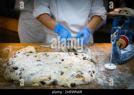 baker weighing bread dough on scale at bakery Stock Photo - Alamy