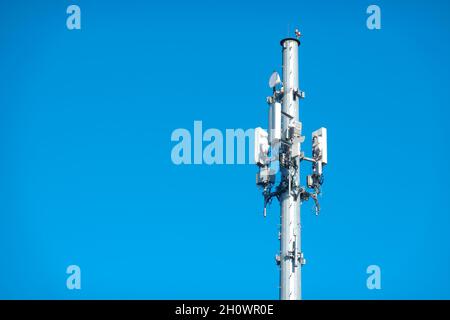 Cell tower against a blue sky. Stock Photo