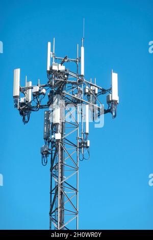 Cell tower against a blue sky. Stock Photo