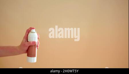 Background photo with a hand who is using a spray Stock Photo