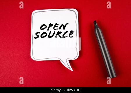 Open Source. Speech bubble and black marker on red background. Stock Photo