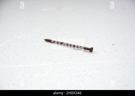 photo of a rusty nail on white background Stock Photo