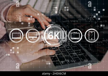 High resolution 6k concept on abstract image with hands and laptop with icons computer, tv and smartphone icons Stock Photo