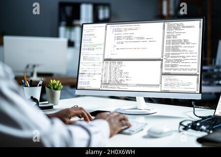 African American Web Coder At Computer. Software Programmer At Night Stock Photo
