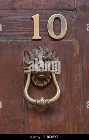 Bronze knocker and number. Quart de les Valls. Comunitat Valenciana. Spain. Stock Photo