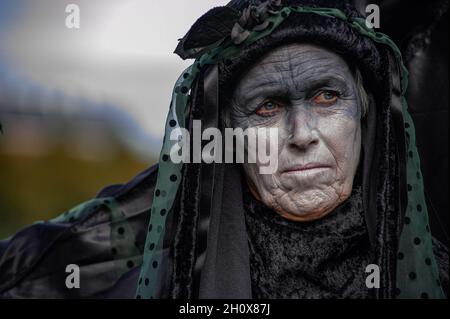 An Extinction Rebellion's silent 'Black-Rebel' stands near the Dutch parliament building during the demonstration.On the fourth-day of climate activities, Extinction Rebellion protesters held a silent march to commemorate the victims of the climate crisis. One-hundred and fifty Extinction Rebellion rebels mostly dressed in black, walked in silence through the streets of The Hague on a four-kilometer march. They carried placards emphasizing the victims of extreme weather during the past year. Leading the silent protest were the 'Black-Rebels', they escorted the funeral procession from the Malie Stock Photo