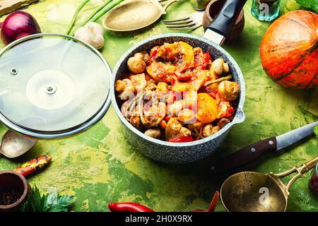 Meat ragout with mushrooms, zucchini, tomato and potatoes. Stew meat Stock Photo
