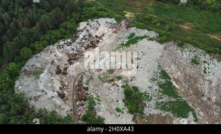 Aerial View Of Domestic Garbage Near Green Forest. Bird's-eye View Of Junk. Domestic Waste In Landfill Junkyard. Eco Concept Garbage Disaster From Stock Photo