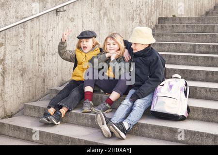 Children sitting on stairs Stock Photo