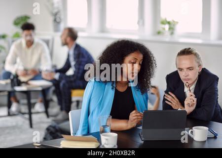 Female coworkers talking in office Stock Photo