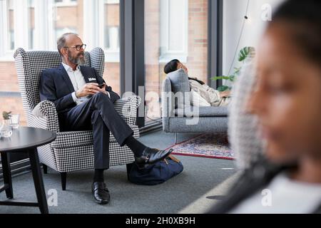 Man sitting in modern office Stock Photo