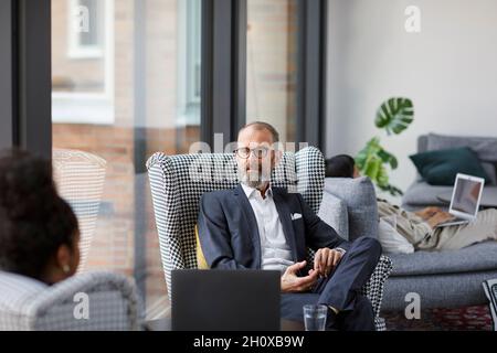 Man sitting in modern office Stock Photo