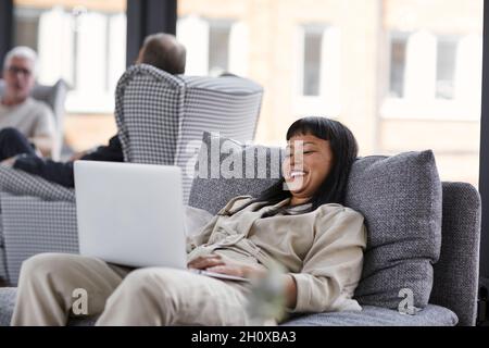 Woman using laptop in office Stock Photo