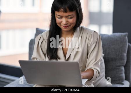 Smiling woman using laptop Stock Photo