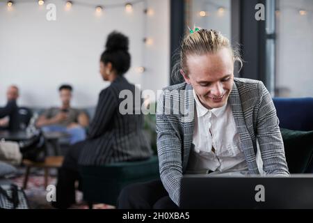 Man in modern office using laptop Stock Photo