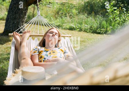Women relaxing on hammock Stock Photo