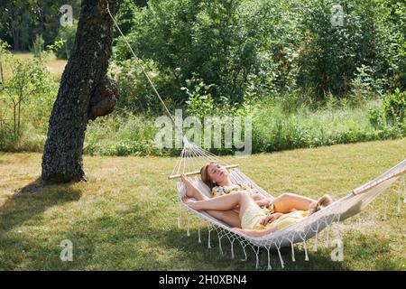 Women relaxing on hammock Stock Photo