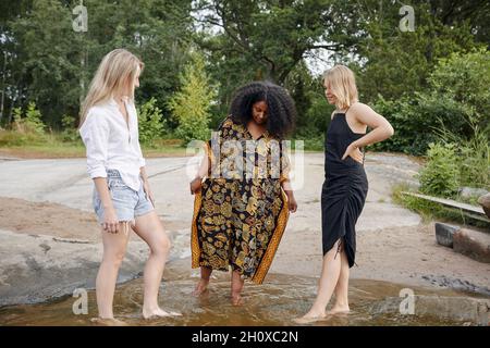 Three young women at lakeshore Stock Photo
