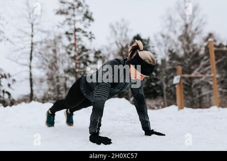 Woman doing push-ups at winter Stock Photo