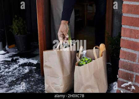 Hand holding paper bag with groceries Stock Photo