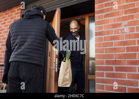 Man having shopping delivered Stock Photo