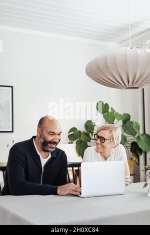 Couple using laptop at home Stock Photo