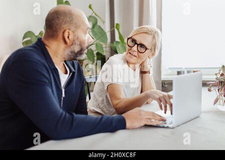 Couple using laptop at home Stock Photo