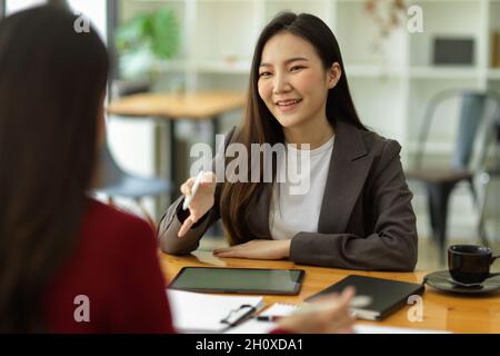 Businesswomen interviewing new employee, business talk negotiation with female business partner or job candidate in the office. employment Stock Photo