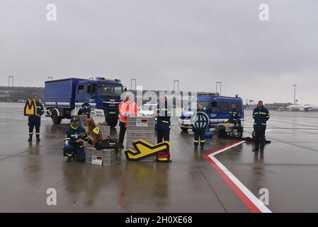 Cologne, Germany. 14th Oct, 2021. Johan Vanneste, Managing Director of Cologne Bonn Airport (red jacket) and Gerd Friedsam, President of the Federal Agency for Technical Relief, vehicles and staff at: Cologne Bonn Airport becomes the hub of the THW, Technical Relief Agency. Cooperation agreement was signed on the apron of CologneBonn Airport Credit: Horst Galuschka/dpa/Alamy Live News Stock Photo