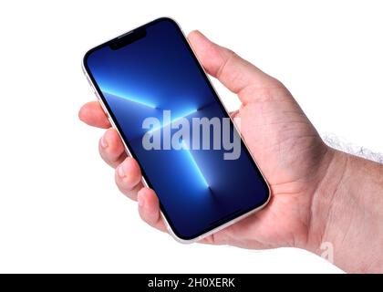 Antalya, TURKEY - October 15, 2021. Hand holding new iphone 13 with new wallpaper on screen Stock Photo