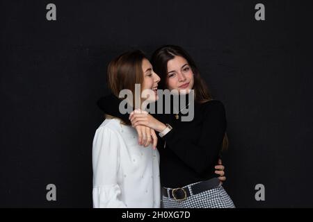 Two beautiful friends hugging each other. Two sisters giving each other love. Couple of girls loving each other. Concept of love Stock Photo