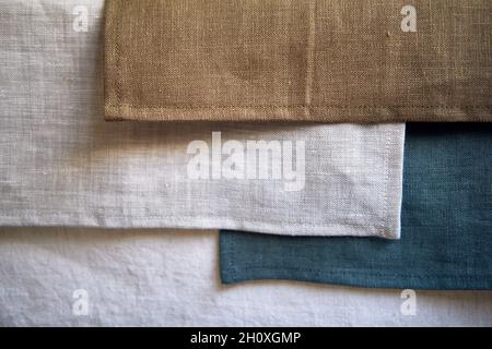 Scraps of natural flax of different colors. Grey, blue, white, brown. Fashionable color palette of natural fabrics. Macro shooting. Stock Photo