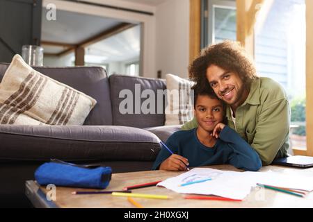 Father and son drawing at home Stock Photo