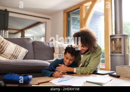 Father and son drawing at home Stock Photo