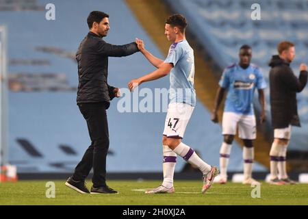 Arsenal manager Mikel Arteta and Manchester City's Phil Foden after the final whistle during the Premier League match at the Etihad Stadium, Manchester.