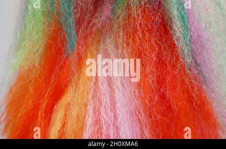 Fluffy wool-like threads in the colors red, orange, yellow, pink, white, green, turquoise Stock Photo