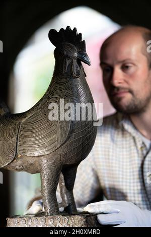 archivist-robert-athol-with-a-bronze-statue-of-a-cockerel-called-the