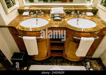 Interior of luxurious bathroom in marble, with two sinks, large mirror, and accessories, deluxe accomodation in the Ritz Carlton Moscow hote, Russia Stock Photo