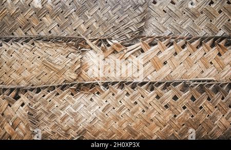 Dried palm leaf braid wall, natural background. Stock Photo
