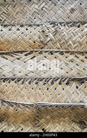 Dried palm leaf braid wall, natural background. Stock Photo